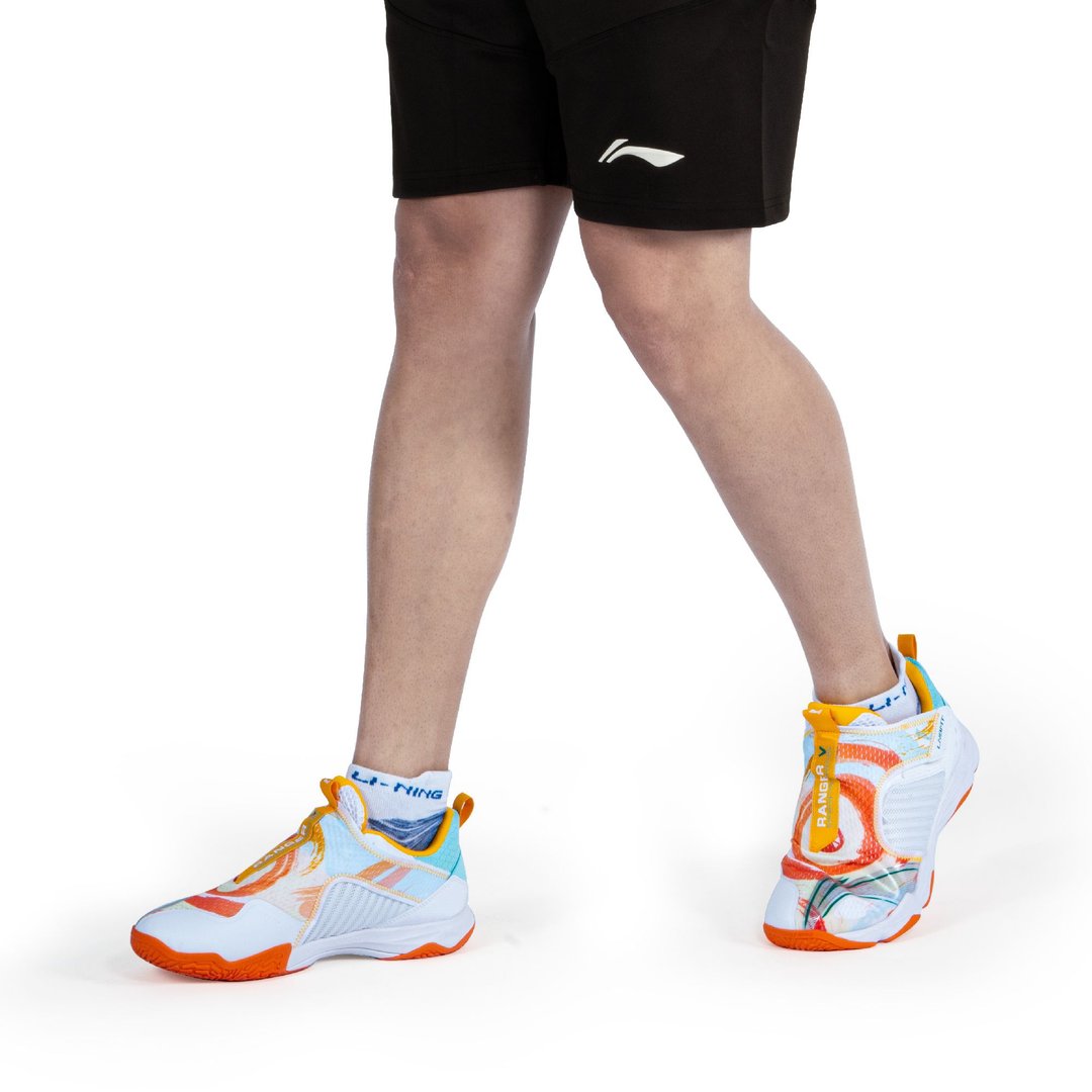 Guy wearing Li-Ning Ranger V Lite Badminton shoes- White, saffron